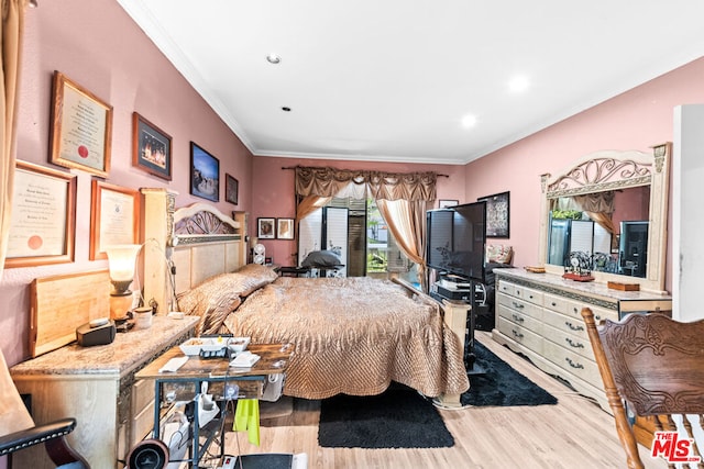 bedroom featuring crown molding and light hardwood / wood-style flooring