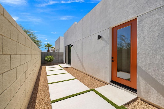 view of exterior entry with a patio area