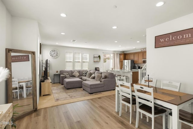 dining space with light hardwood / wood-style flooring