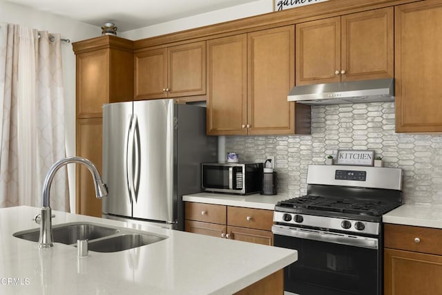 kitchen featuring tasteful backsplash, sink, and appliances with stainless steel finishes