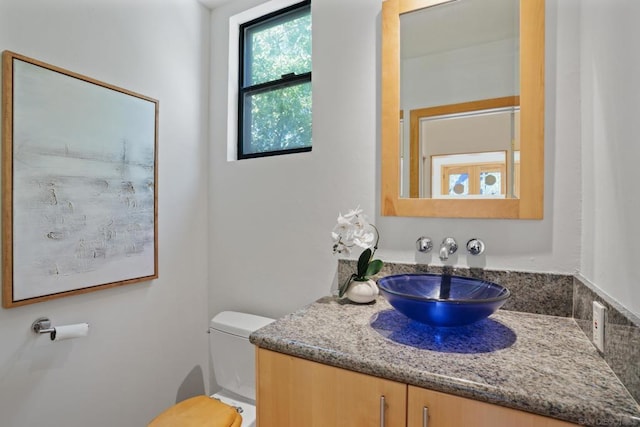 bathroom featuring vanity and toilet