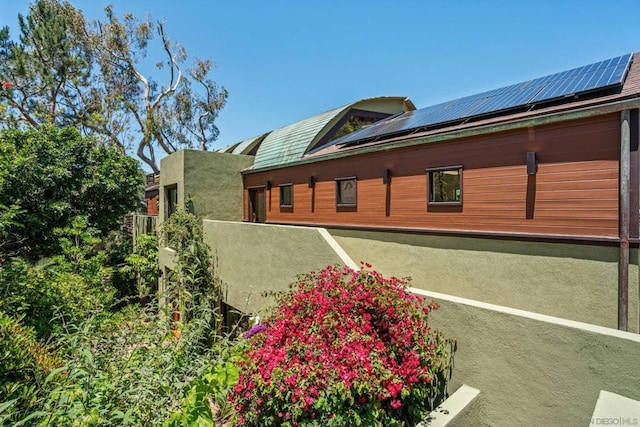 view of home's exterior featuring solar panels