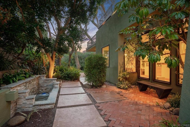 view of patio terrace at dusk