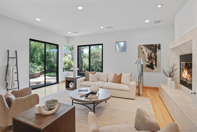 living room with a fireplace and light hardwood / wood-style floors