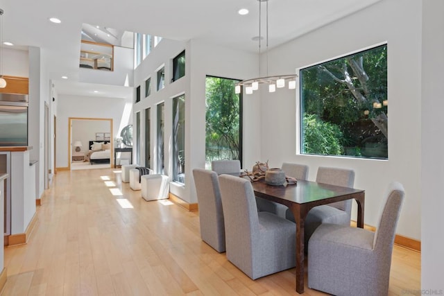 dining area with a notable chandelier and light wood-type flooring