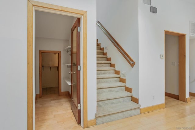 staircase with wood-type flooring