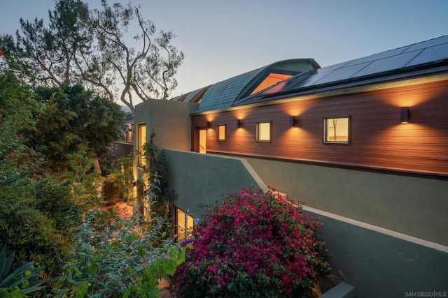 property exterior at dusk featuring solar panels