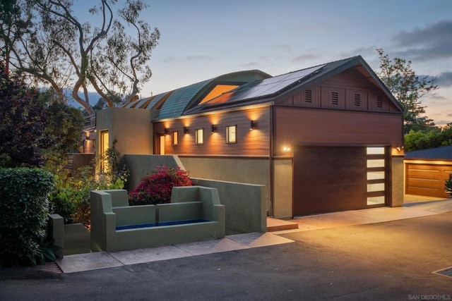 view of front of house with a garage and solar panels