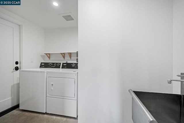 clothes washing area featuring sink and independent washer and dryer