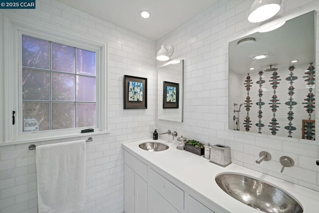 bathroom with tasteful backsplash, vanity, and tile walls