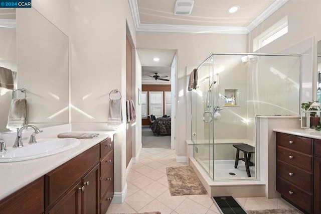 bathroom featuring ceiling fan, tile patterned flooring, walk in shower, ornamental molding, and vanity