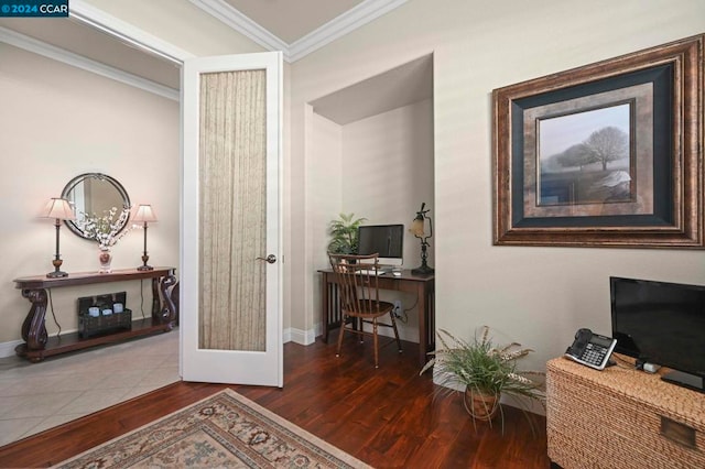 hallway featuring dark wood-type flooring, ornamental molding, and french doors