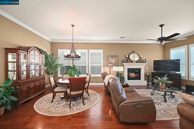 living room featuring ornamental molding, ceiling fan with notable chandelier, and dark hardwood / wood-style floors