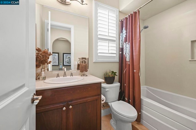 full bathroom with shower / bath combo with shower curtain, toilet, vanity, and tile patterned flooring