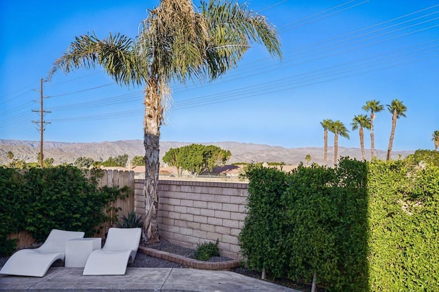 exterior space featuring a mountain view and a patio area