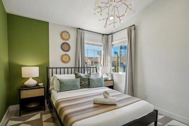 carpeted bedroom with an inviting chandelier