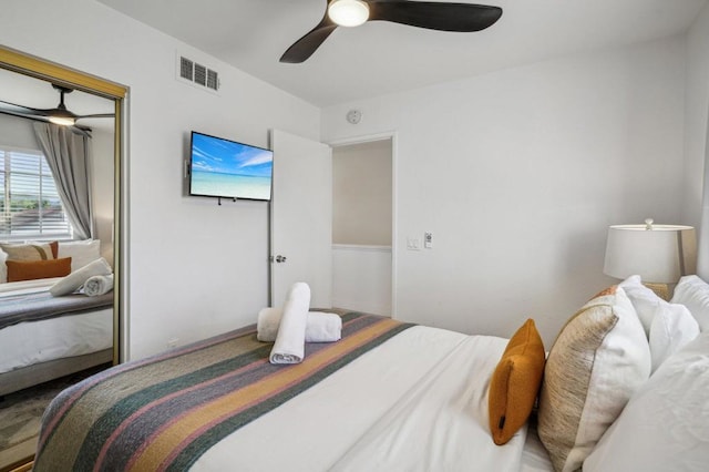 bedroom featuring ceiling fan and a closet