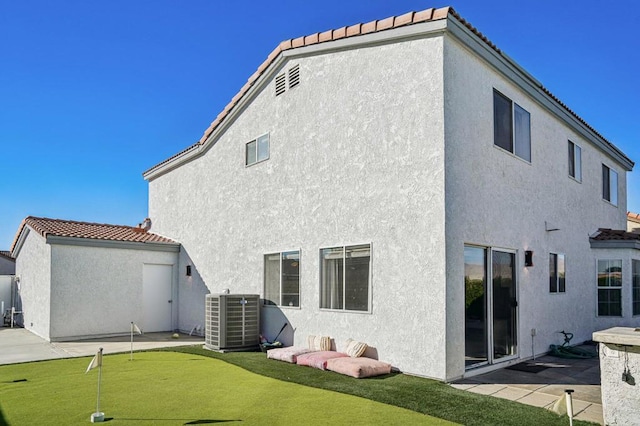 rear view of house with cooling unit and a patio area