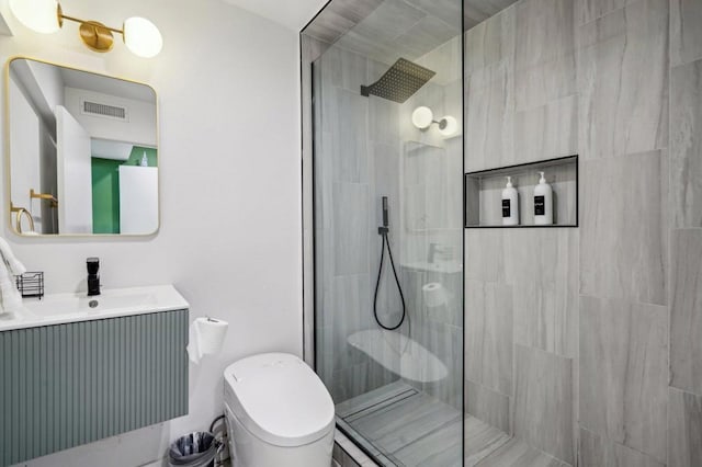 bathroom with vanity and a tile shower