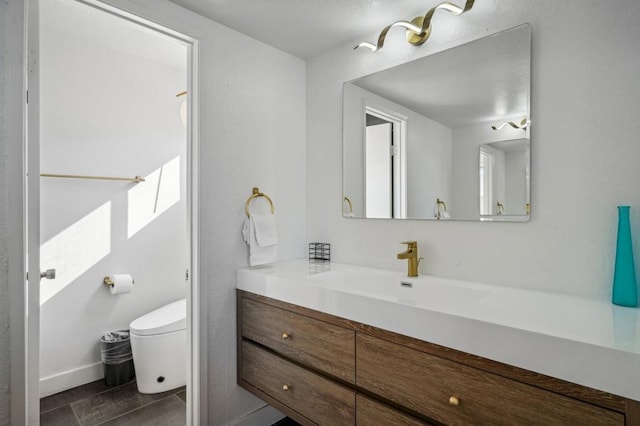 bathroom with vanity and toilet