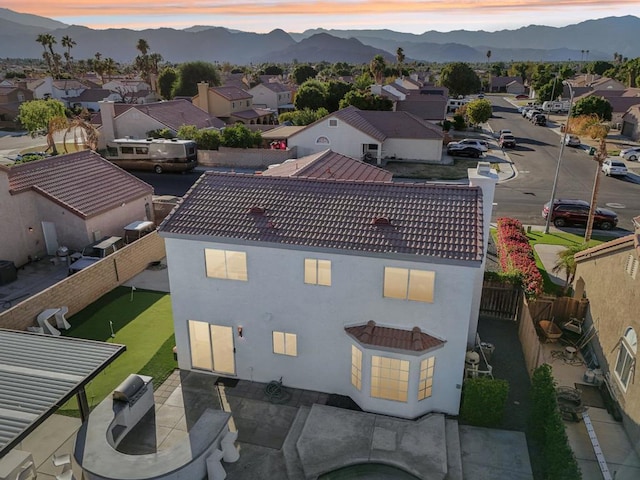 aerial view at dusk featuring a mountain view