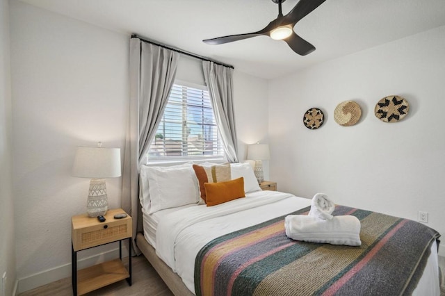 bedroom with ceiling fan and wood-type flooring