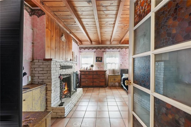 kitchen featuring a fireplace, light tile patterned floors, wood ceiling, and beamed ceiling