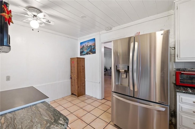 kitchen featuring stainless steel refrigerator with ice dispenser, wood ceiling, ceiling fan, light tile patterned floors, and white cabinets