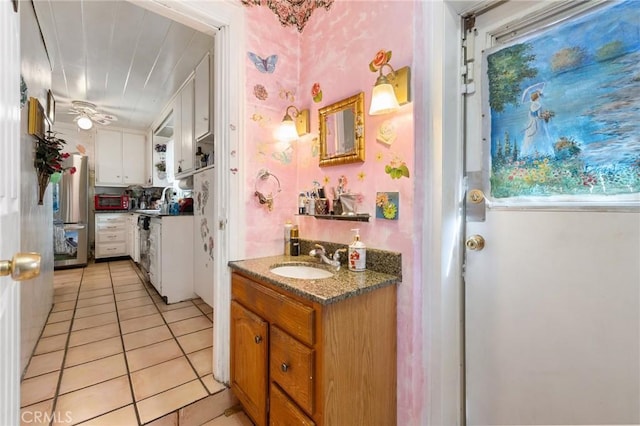 bathroom featuring tile patterned flooring, ceiling fan, and vanity