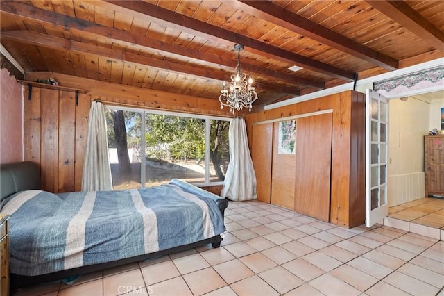 bedroom featuring multiple windows, wood walls, light tile patterned flooring, and wood ceiling