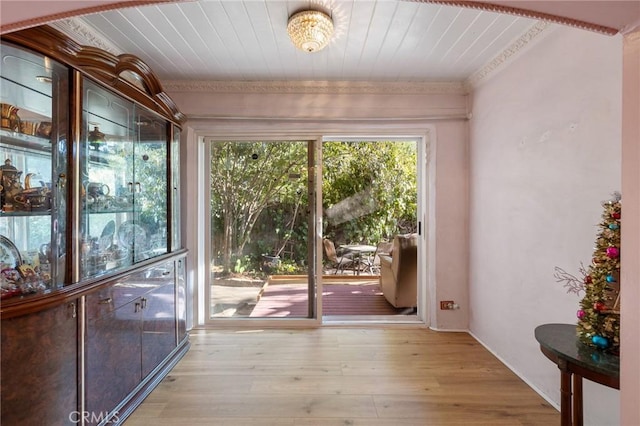 doorway to outside with light wood-type flooring, crown molding, and wood ceiling