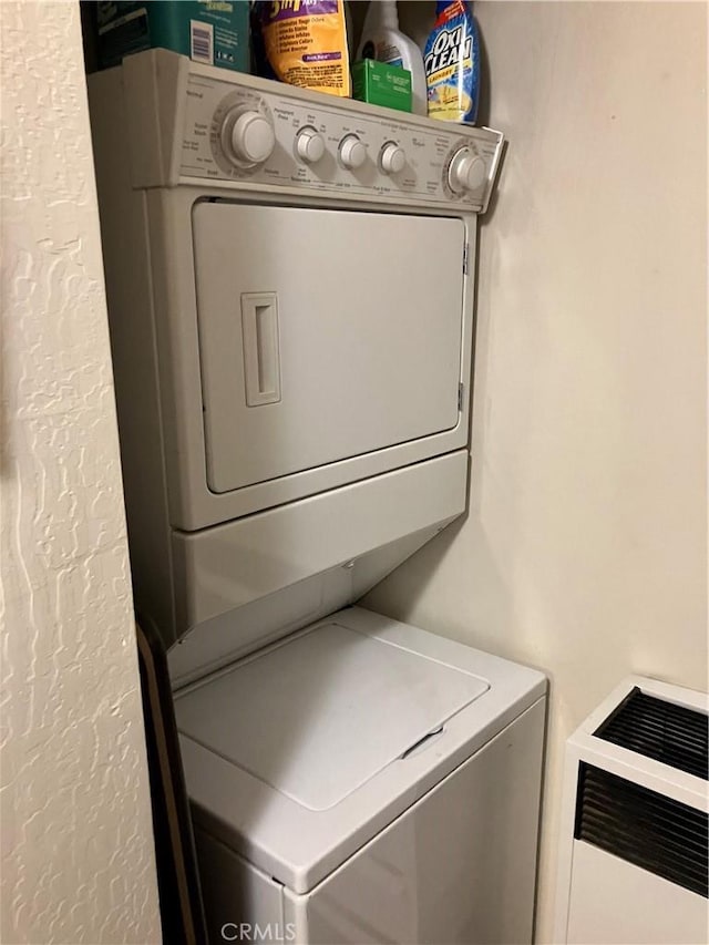 laundry area with stacked washer and dryer