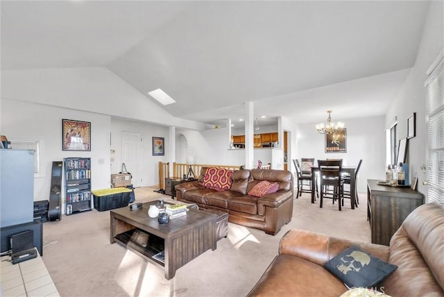 carpeted living room featuring vaulted ceiling and a notable chandelier