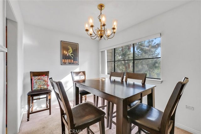 dining room with a notable chandelier and light colored carpet