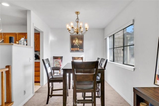 carpeted dining space featuring a notable chandelier