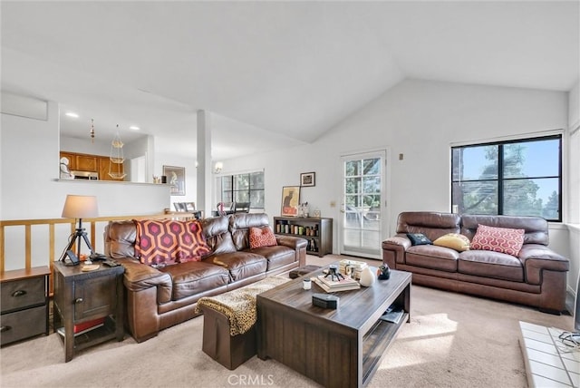 living room featuring light colored carpet and high vaulted ceiling