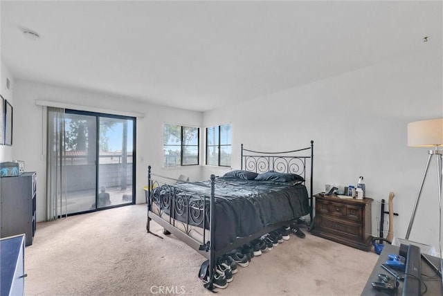 bedroom featuring access to outside and light carpet