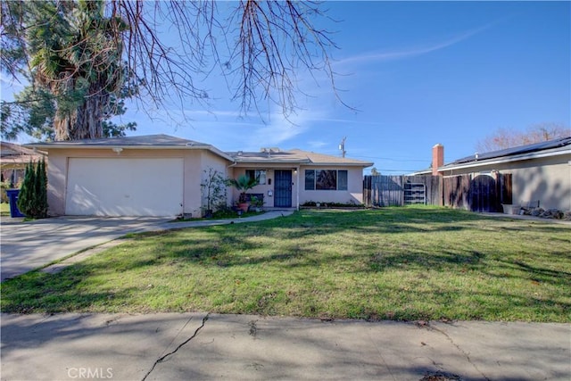 ranch-style house featuring a garage and a front lawn