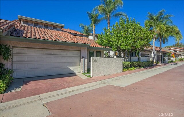 mediterranean / spanish home featuring a garage