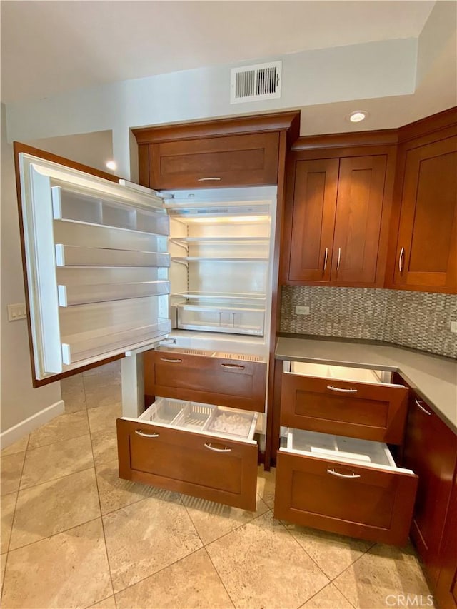 kitchen featuring light tile patterned floors and tasteful backsplash