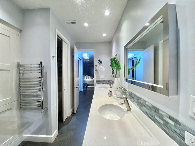 bathroom featuring tile patterned floors, radiator, and vanity