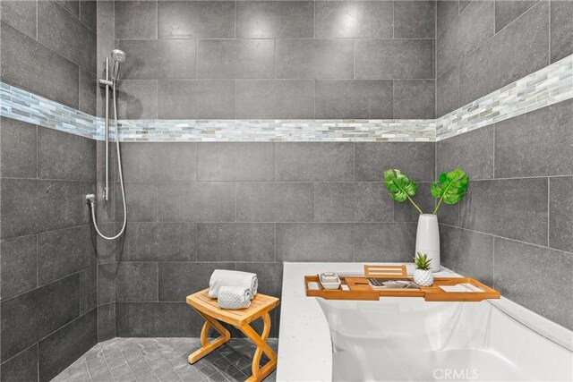 bathroom with a tile shower