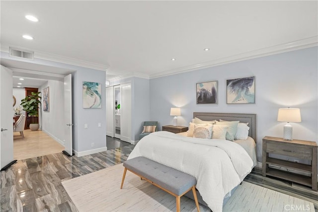 bedroom with ornamental molding and hardwood / wood-style floors