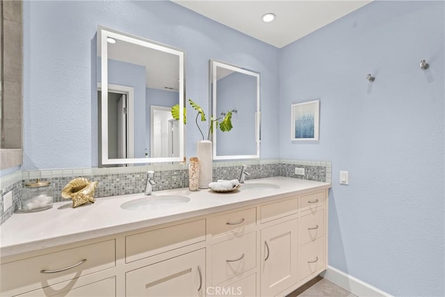 bathroom featuring decorative backsplash and vanity