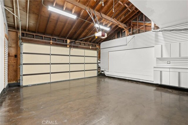 garage featuring wooden ceiling and a garage door opener