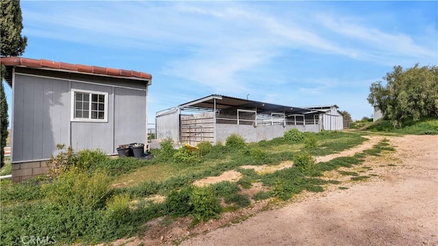 view of side of home with an outdoor structure