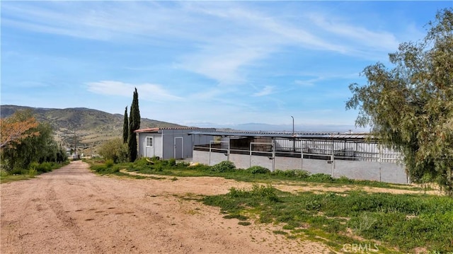 view of stable featuring a mountain view