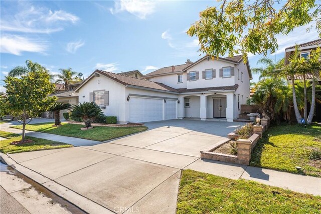 view of front property featuring a front yard and a garage