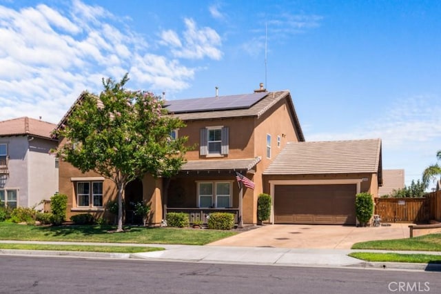 view of front of property featuring a front yard, a garage, and solar panels