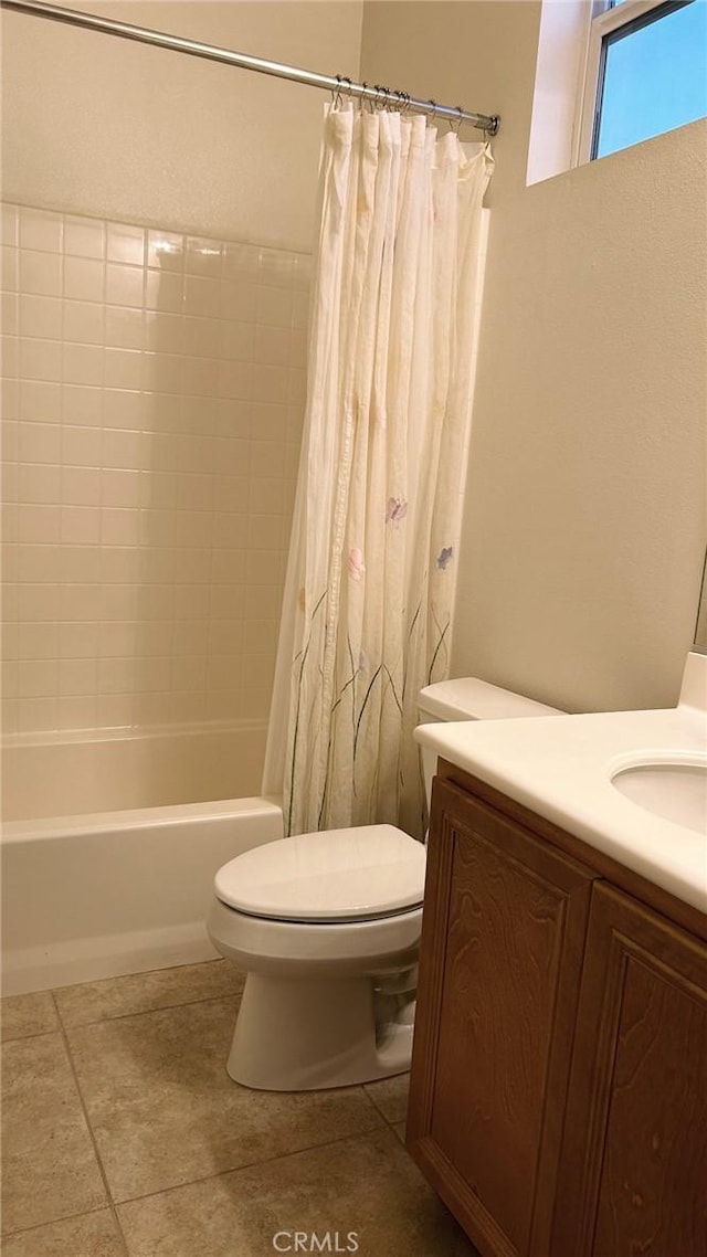 full bathroom featuring toilet, tile patterned flooring, shower / tub combo with curtain, and vanity